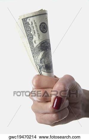 Close-up of a woman's hand holding one hundred dollar bills View Large Photo Image Picture - Close-up of a woman's hand holding one hundred dollar bills. Fotosearch