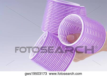 Close-up of a woman's hand holding curlers View Large Photo Image Stock Image - Close-up of a woman's hand holding curlers. Fotosearch