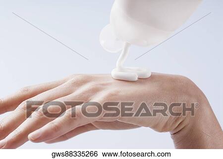 Close-up of a woman's hand pouring moisturizer View Large Photo Image Stock Photograph - Close-up of a woman's hand pouring moisturizer. Fotosearch