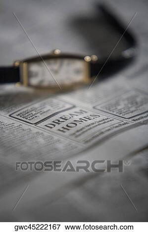 Close-up of a wristwatch on a newspaper View Large Photo Image Stock Photo - Close-up of a wristwatch on a newspaper. Fotosearch