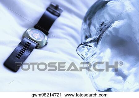 Close-up of a wristwatch with a glass statue View Large Photo Image Stock Image - Close-up of a wristwatch with a glass statue. Fotosearch