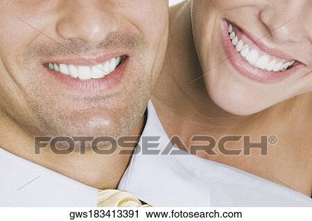 Close-up of a young couple smiling View Large Photo Image Stock Image - Close-up of a young couple smiling. Fotosearch