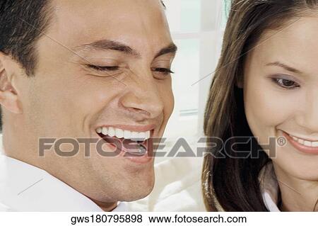 Close-up of a young couple smiling View Large Photo Image Stock Photo - Close-up of a young couple smiling. Fotosearch