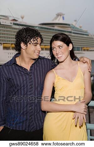 Close-up of a young man and a teenage girl looking at each other and smiling View Large Photo Image Stock Photo - Close-up of a young man and a teenage girl looking at each other and smiling. Fotosearch