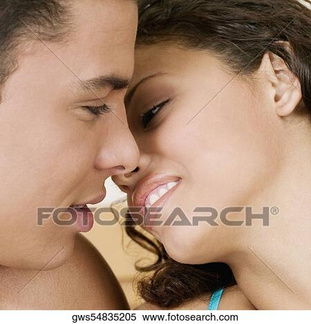 Close-up of a young man and a teenage girl facing each other View Large Photo Image Stock Photography - Close-up of a young man and a teenage girl facing each other. Fotosearch