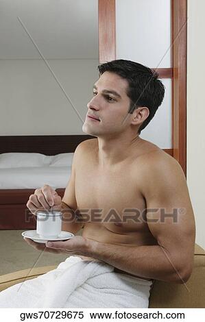 Close-up of a young man holding a cup of tea View Large Photo Image Stock Photography - Close-up of a young man holding a cup of tea. Fotosearch