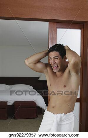 Close-up of a young man laughing with his hands behind his head View Large Photo Image Stock Photo - Close-up of a young man laughing with his hands behind his head. Fotosearch