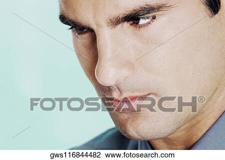 Stock Image - Close-up of a young man looking serious. Fotosearch