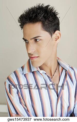 Close-up of a young man looking sideways View Large Photo Image Stock Photo - Close-up of a young man looking sideways. Fotosearch