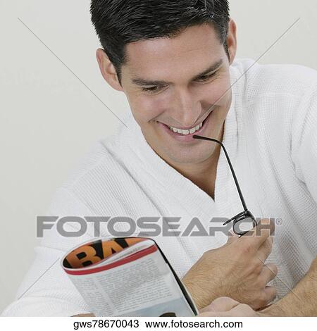 Close-up of a young man reading a magazine View Large Photo Image Stock Image - Close-up of a young man reading a magazine. Fotosearch