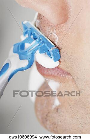 Close-up of a young man shaving View Large Photo Image Picture - Close-up of a young man shaving. Fotosearch