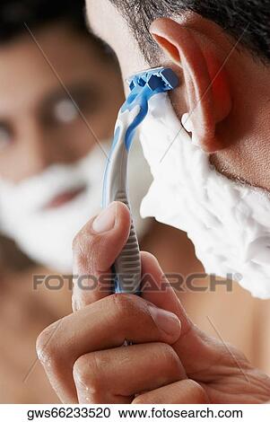 Close-up of a young man shaving View Large Photo Image Stock Image - Close-up of a young man shaving. Fotosearch