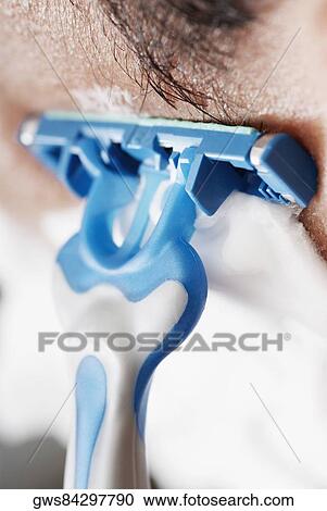 Close-up of a young man shaving View Large Photo Image Stock Image - Close-up of a young man shaving. Fotosearch
