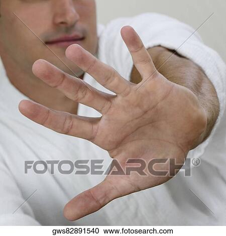 Close-up of a young man showing a stop gesture View Large Photo Image Stock Image - Close-up of a young man showing a stop gesture. Fotosearch