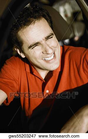 Close-up of a young man sitting in a car and smiling View Large Photo Image Stock Photo - Close-up of a young man sitting in a car and smiling. Fotosearch