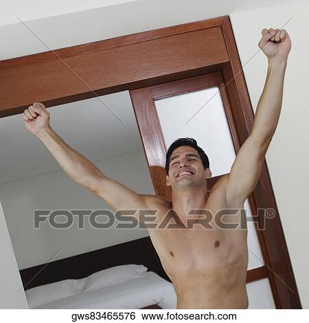 Close-up of a young man standing with his arms outstretched View Large Photo Image Stock Photograph - Close-up of a young man standing with his arms outstretched. Fotosearch