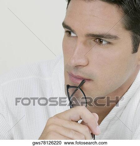 Close-up of a young man thinking View Large Photo Image Stock Image - Close-up of a young man thinking. Fotosearch