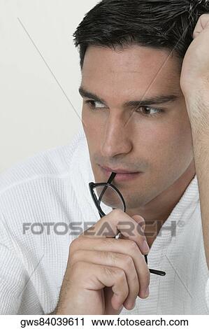 Close-up of a young man thinking View Large Photo Image Stock Image - Close-up of a young man thinking. Fotosearch
