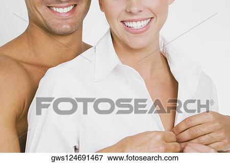 Close-up of a young man undressing a young woman View Large Photo Image Stock Photo - Close-up of a young man undressing a young woman. Fotosearch