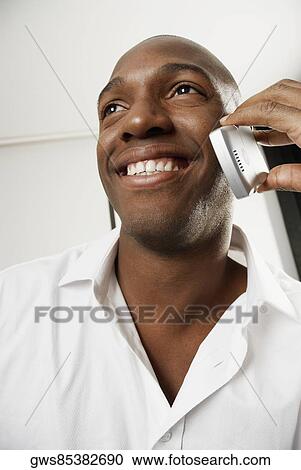Close-up of a young man using a mobile phone View Large Photo Image Stock Image - Close-up of a young man using a mobile phone. Fotosearch