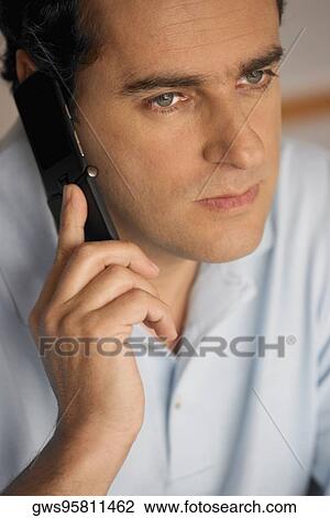 Close-up of a young man using a mobile phone View Large Photo Image Stock Image - Close-up of a young man using a mobile phone. Fotosearch