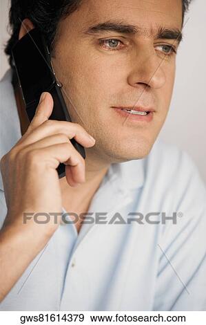 Close-up of a young man using a mobile phone View Large Photo Image Stock Photo - Close-up of a young man using a mobile phone. Fotosearch