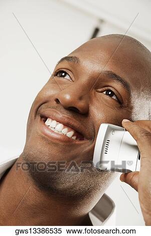 Close-up of a young man using a mobile phone View Large Photo Image Stock Photography - Close-up of a young man using a mobile phone. Fotosearch