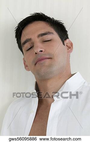 Stock Photograph - Close-up of a young man with his eyes closed. Fotosearch