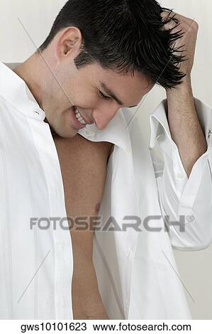 Close-up of a young man with his hand in his hair View Large Photo Image Stock Image - Close-up of a young man with his hand in his hair. Fotosearch