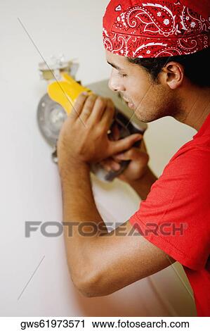 Close-up of a young man working with a circular saw View Large Photo Image Stock Image - Close-up of a young man working with a circular saw. Fotosearch