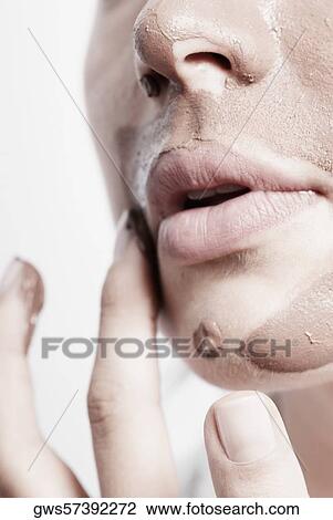 Close-up of a young woman applying a facial mask View Large Photo Image Stock Image - Close-up of a young woman applying a facial mask. Fotosearch