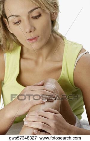 Close-up of a young woman applying hair removing cream on her leg View Large Photo Image Stock Photo - Close-up of a young woman applying hair removing cream on her leg. Fotosearch