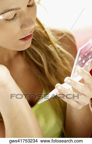 Close-up of a young woman applying eyeshadow View Large Photo Image Picture - Close-up of a young woman applying eyeshadow. Fotosearch