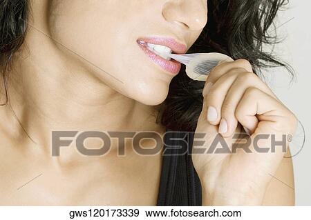 Close-up of a young woman biting a condom View Large Photo Image Stock Photo - Close-up of a young woman biting a condom. Fotosearch
