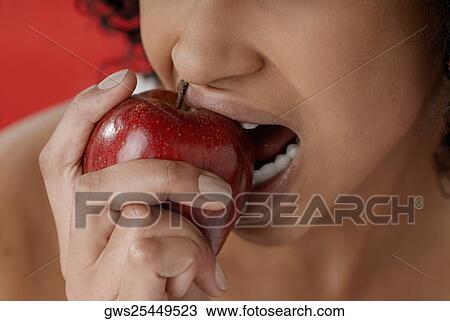 Close-up of a young woman eating an apple View Large Photo Image Stock Image - Close-up of a young woman eating an apple. Fotosearch