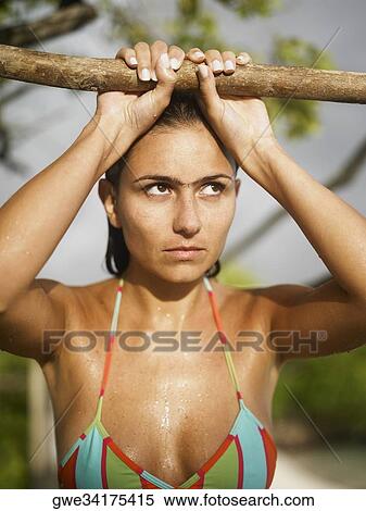 Close-up of a young woman holding a log View Large Photo Image Stock Photography - Close-up of a young woman holding a log. Fotosearch