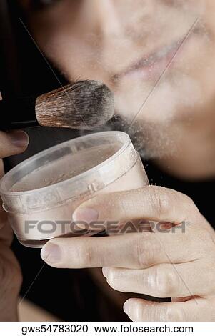Close-up of a young woman holding a make-up brush and face powder View Large Photo Image Stock Image - Close-up of a young woman holding a make-up brush and face powder. Fotosearch