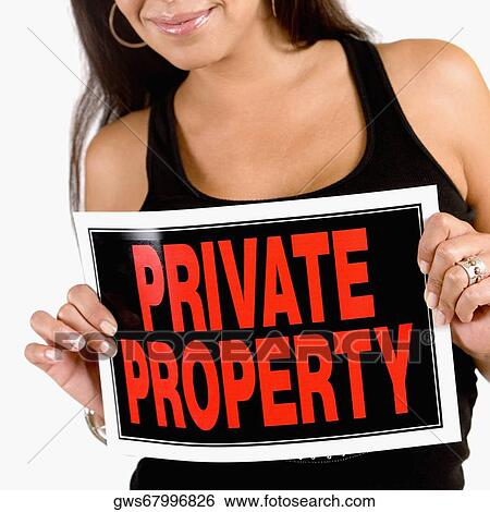 Close-up of a young woman holding a Private Property sign View Large Photo Image Stock Photograph - Close-up of a young woman holding a Private Property sign. Fotosearch
