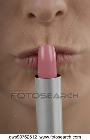 Close-up of a young woman kissing a lipstick View Large Photo Image Stock Image - Close-up of a young woman kissing a lipstick. Fotosearch