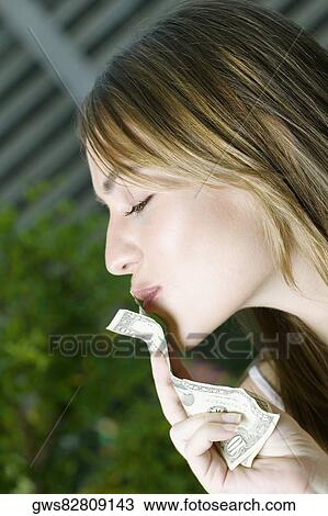 Close-up of a young woman kissing American dollar bills View Large Photo Image Stock Image - Close-up of a young woman kissing American dollar bills. Fotosearch