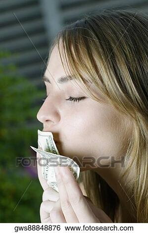 Close-up of a young woman kissing American dollar bills View Large Photo Image Stock Photograph - Close-up of a young woman kissing American dollar bills. Fotosearch
