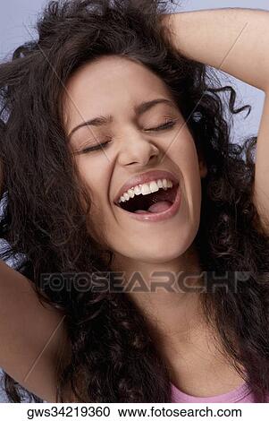 Close-up of a young woman laughing View Large Photo Image Stock Image - Close-up of a young woman laughing. Fotosearch