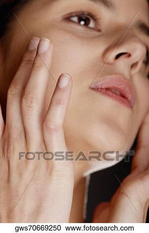Close-up of a young woman looking away View Large Photo Image Stock Image - Close-up of a young woman looking away. Fotosearch