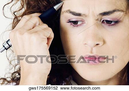 Close-up of a young woman looking serious View Large Photo Image Stock Image - Close-up of a young woman looking serious. Fotosearch