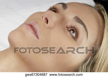 Close-up of a young woman looking up View Large Photo Image Stock Photo - Close-up of a young woman looking up. Fotosearch