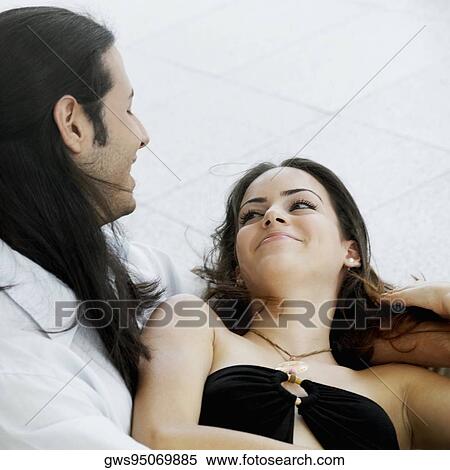 Close-up of a young woman lying on a young man's lap View Large Photo Image Stock Photography - Close-up of a young woman lying on a young man's lap. Fotosearch