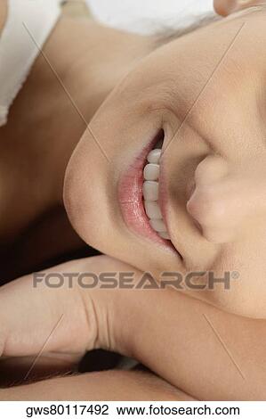 Stock Image - Close-up of a young woman smiling. Fotosearch