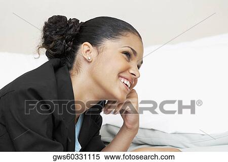 Close-up of a young woman smiling View Large Photo Image Stock Photography - Close-up of a young woman smiling. Fotosearch