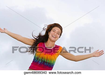 Close-up of a young woman standing with her arms outstretched View Large Photo Image Stock Image - Close-up of a young woman standing with her arms outstretched. Fotosearch