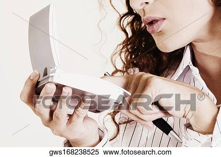 Close-up of a young woman using a calculator View Large Photo Image Stock Photography - Close-up of a young woman using a calculator. Fotosearch